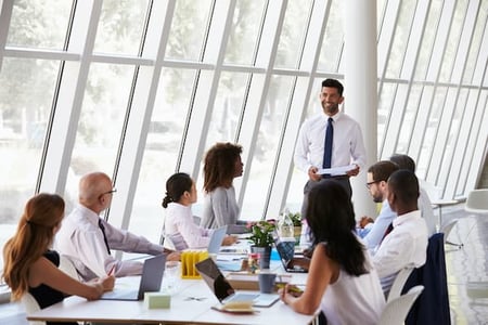board of directors listens to man's presentation