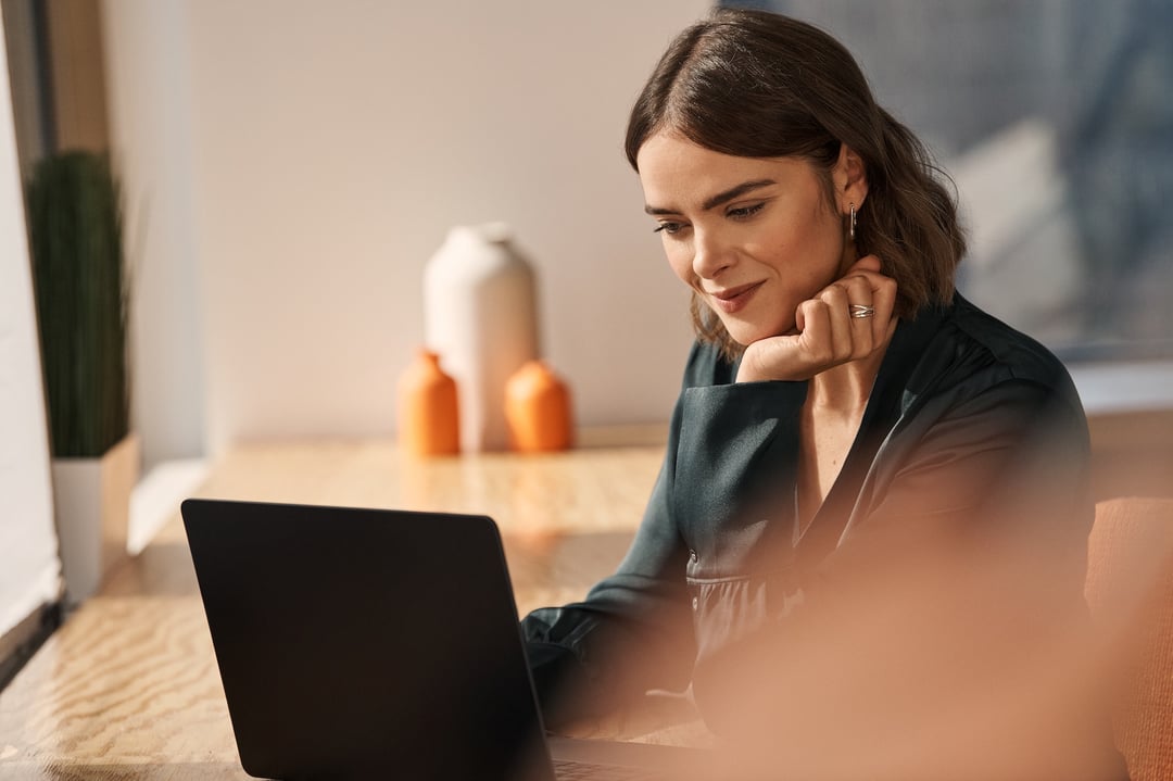 Woman looking at laptop