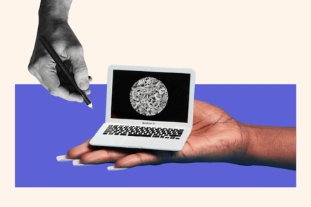 A tiny laptop in the palm of a hand