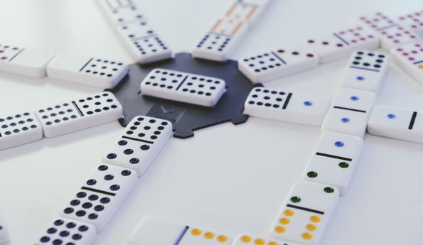 Arranged dominos lying flat, converging around a singular domino