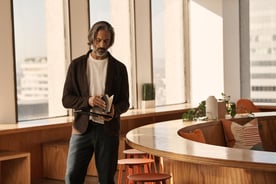Man standing in office with book