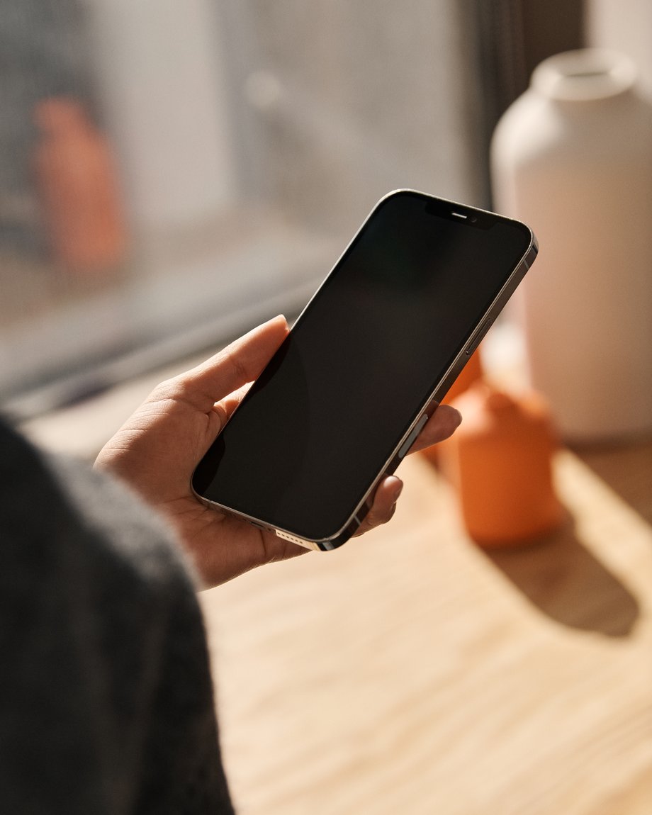 Woman holding phone OTS