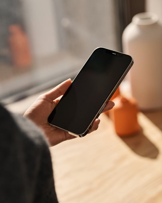 Woman holding phone OTS