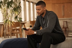 Man office lounge typing on phone