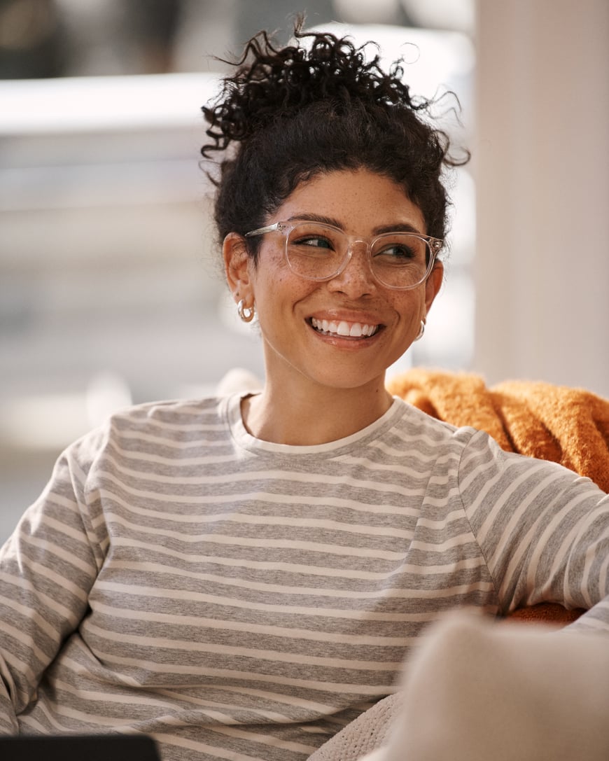 Woman on couch smiling