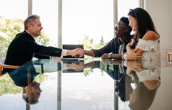 executives shaking hands and discussing the company's customer acquisition cost