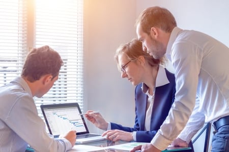 Data governance strategy being reviewed by three employees