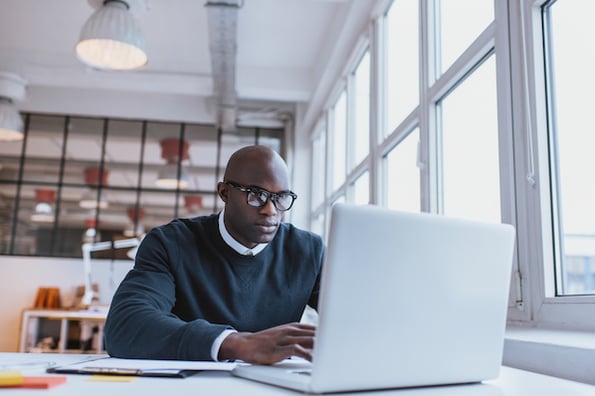 Developer using his laptop to customize a starter WordPress theme