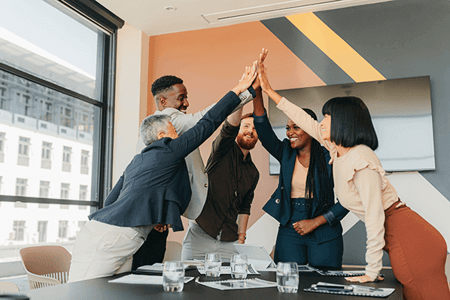Team freut sich über effektiven Sales-Enablement-Content und gibt sich High Five