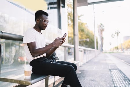 man using a smartphone to access an amp plugin for wordpress