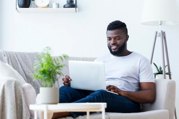 man using a laptop to install a Google AdSense alternative on his blog website