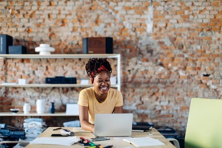 person using a computer in an office to download a wordpress file upload plugin