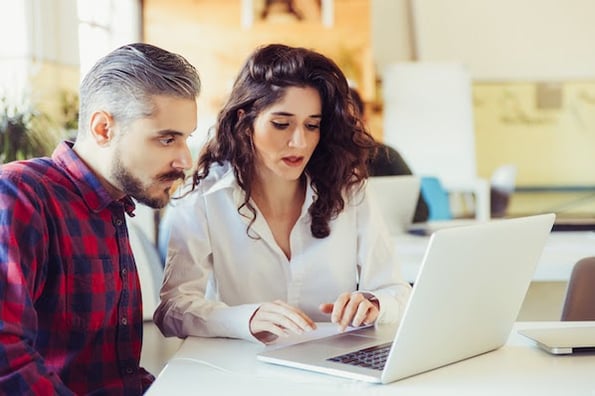 two people using a laptop computer to resolve a 413 request entity too large error