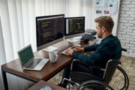 person using a laptop at their desk practicing implementing api design best practices 