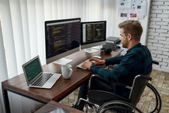 person using a laptop at their desk practicing implementing api design best practices