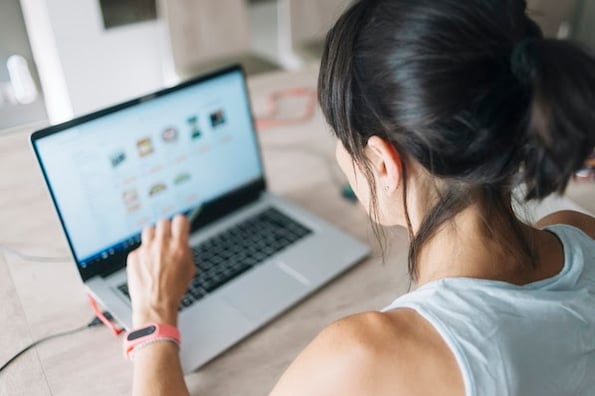 person using a laptop to install an amazon affiliate wordpress plugin