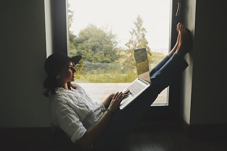 Woman reading up on how to become a web developer 