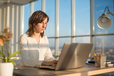 person using a laptop to nest CSS code