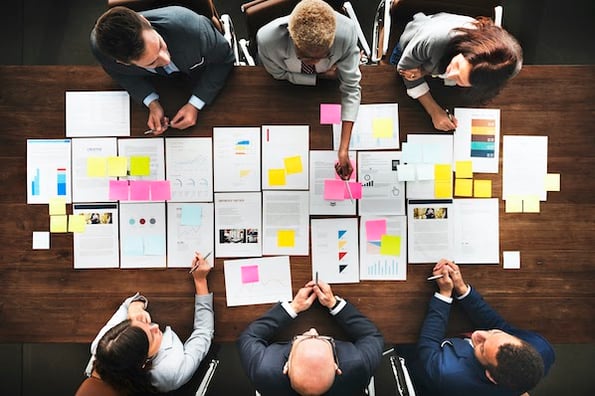 businesspeople sitting at a conference table planning a data-driven website design process