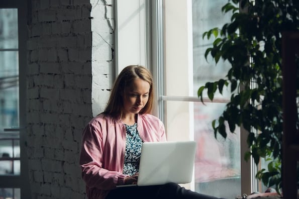 woman learning how to inspect a webpage on her laptop