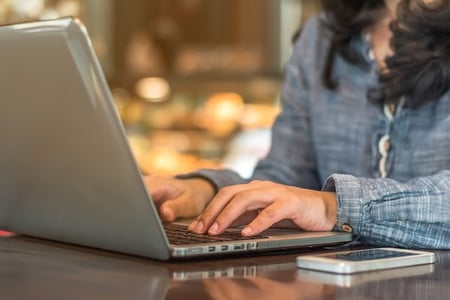 person using a laptop computer to customize their website typography