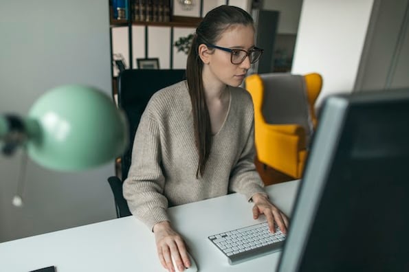 person using a desktop computer to program Bulma CSS