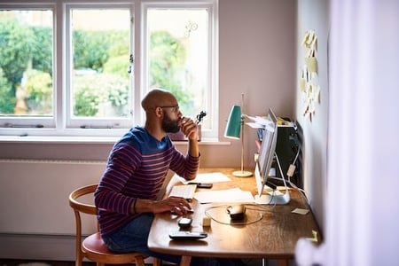 man using a desktop computer to browse google font plugins for wordpress