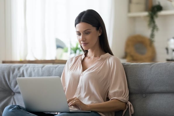 woman using a computer to migrate her WordPress site to a new host