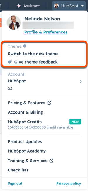 Profile dropdown in HubSpot showing Theme section with options to switch to the new theme and give theme feedback.