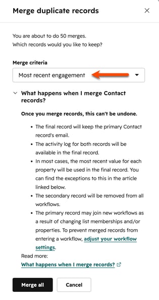HubSpot Merge duplicate records dialog with the Merge criteria dropdown set to "Most recent engagement," highlighted by an orange arrow.