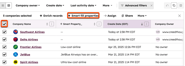 A HubSpot companies table view with five companies selected. A bulk action bar above the table shows a highlighted 'Smart fill properties' button.
