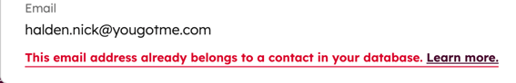 A contact's email property showing a red message stating the address already belongs to another contact in the database.