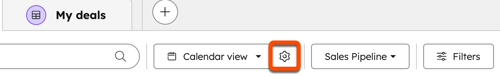 A settings gear icon next to the view type button is highlighted with an orange box on a HubSpot deals page.
