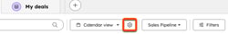 A settings gear icon next to the view type button is highlighted with an orange box on a HubSpot deals page.
