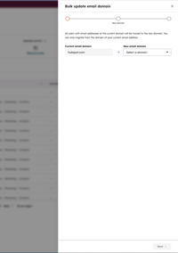 Bulk update email domain dialog box in HubSpot showing the current domain set to hubspot.com and a dropdown to select a new email domain.