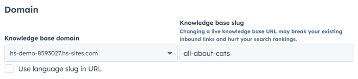 Knowledge base settings page showing the "Domain" section on the "General tab". On the left, under "Knowledge base domain," a dropdown field shows a domain selected. Below it, a checkbox for "Use language slug in URL". On the right, under "Knowledge base slug," a text field shows example text entered. There is a warning text above the slug field about changing a live knowledge base URL.
