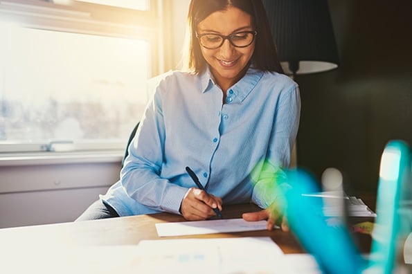 woman making a SMART goal in her planner