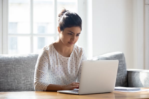person sitting on a couch using a laptop computer to fix an SSL certificate error