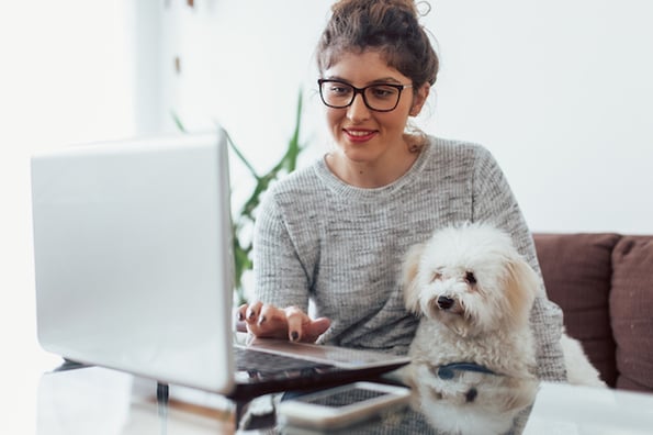 woman using a laptop computer at a desk to use the CSS float property