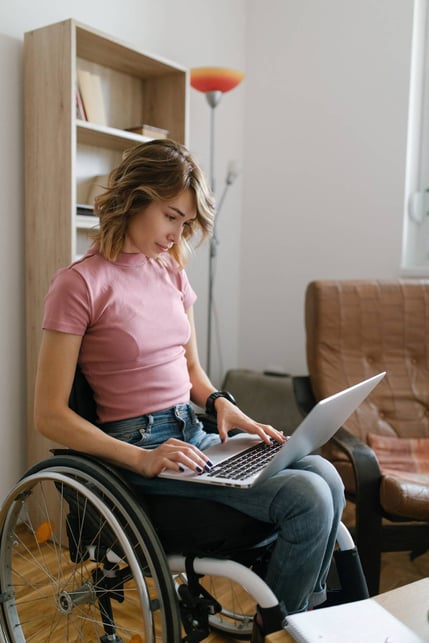 Woman in wheelchair working remote on laptop