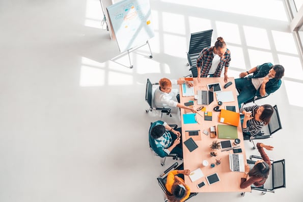 group of people discussing membership website builders in a conference room