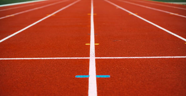 Closeup, ground view of running track lines.