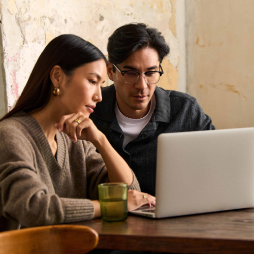 Man and woman looking at laptop