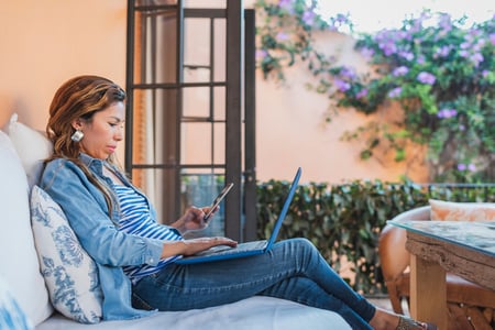 Person looking on her laptop at WordPress theme travel blog style. 
