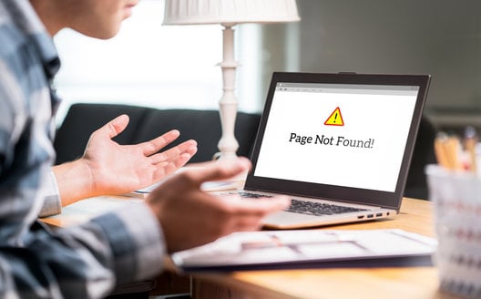 person reacting negatively to the WordPress white screen of death on their laptop