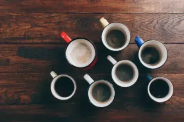 accessible website examples, image of seven full coffee mugs on a wooden table