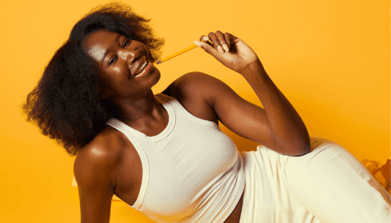 woman holding pencil and smiling