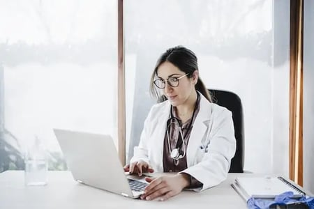 Doctor installing wordpress health theme for their website 