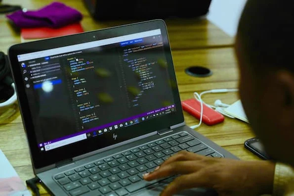 person using a computer to code in a beginner programming language