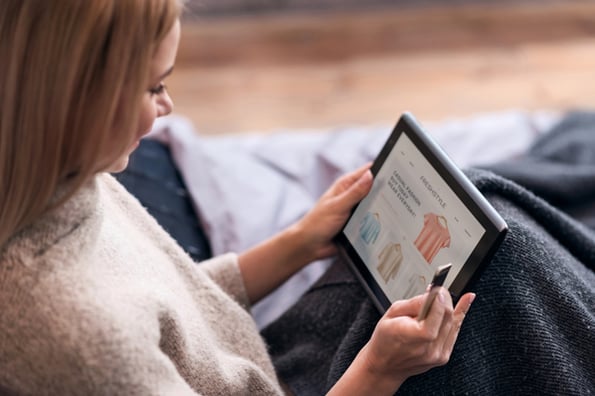 Woman looking at clothes on website displayed via WooCommerce product slider plugin